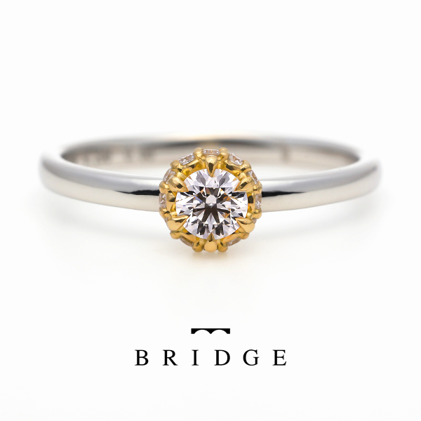 かわいくて人気の婚約指輪BRIDGE日狩りのメビウスは、プラチナとゴールドのコンビネーションがオシャレ。
